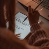 person writing on white paper