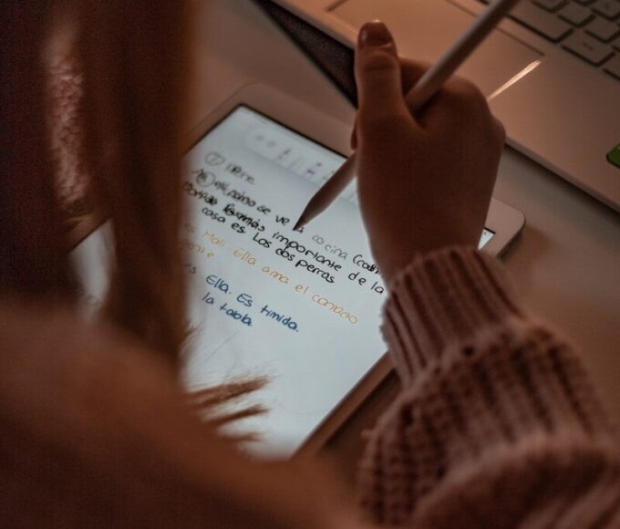 person writing on white paper