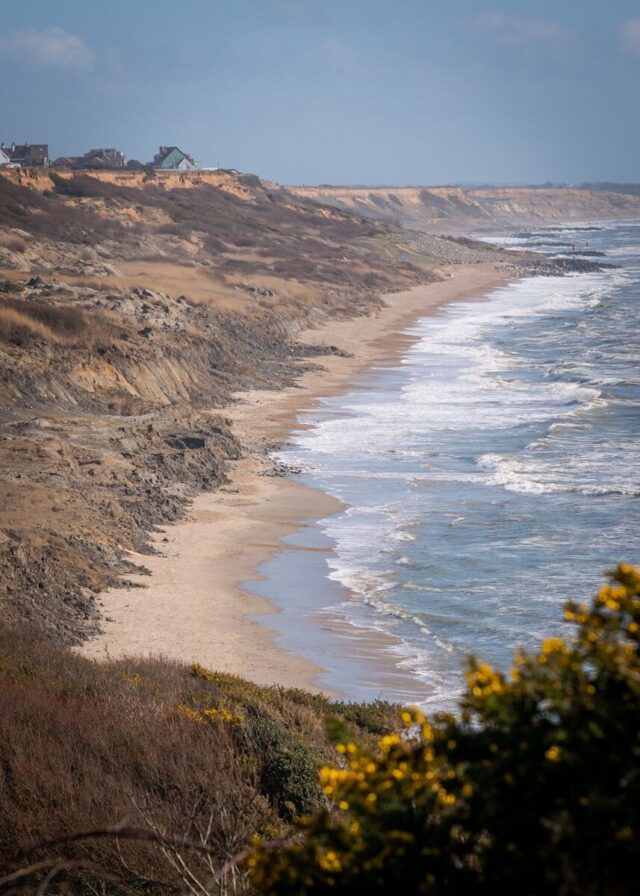 Experience the natural beauty of Christchurch's rugged coastline with waves gently crashing on the shore.