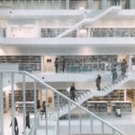 Spacious and minimalist design of the Stuttgart City Library showcasing multiple levels of books and people.