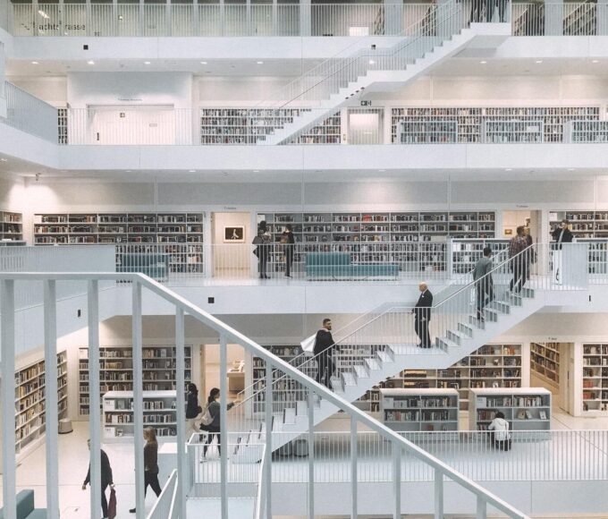 Spacious and minimalist design of the Stuttgart City Library showcasing multiple levels of books and people.