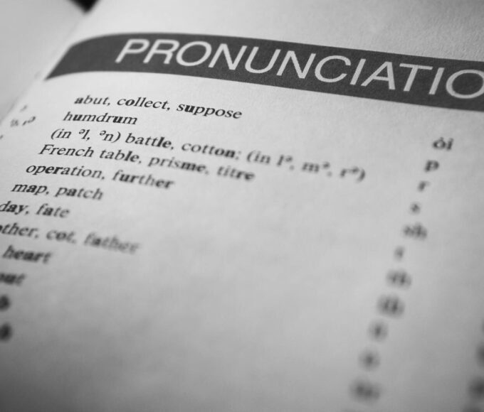 Black and white close-up of a dictionary page focused on pronunciation guides and phonetic symbols.