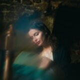 A woman sitting in a chair in a dark room